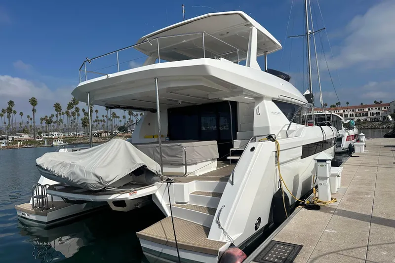 Hamlet Yacht Photos Pics 2023 Leopard 46PC yacht docked at marina with palm trees in background.