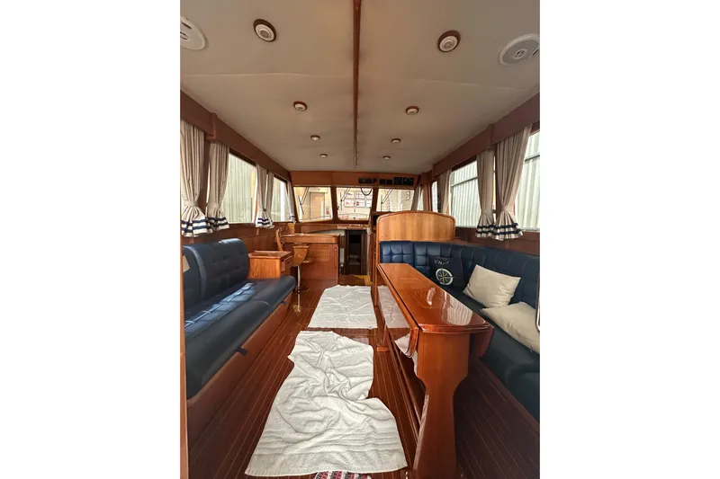 Chief Yacht Photos Pics Interior of 2000 Grand Banks 43 Eastbay FB yacht with elegant wood finish and seating.