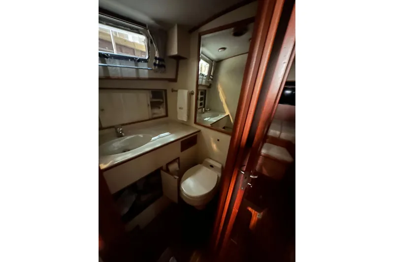 Chief Yacht Photos Pics Bathroom interior of 2000 Grand Banks 43 Eastbay FB yacht, featuring sink and toilet.