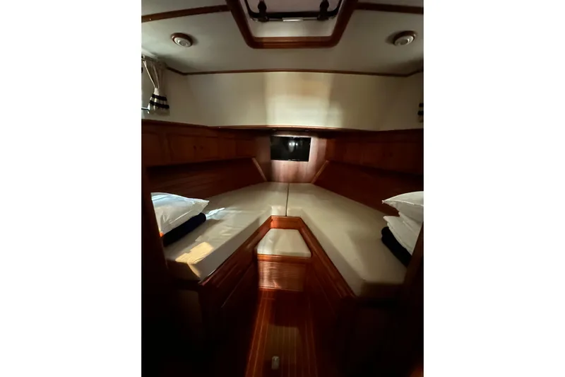 Chief Yacht Photos Pics Cozy cabin interior of 2000 Grand Banks 43 Eastbay FB yacht with wooden accents.