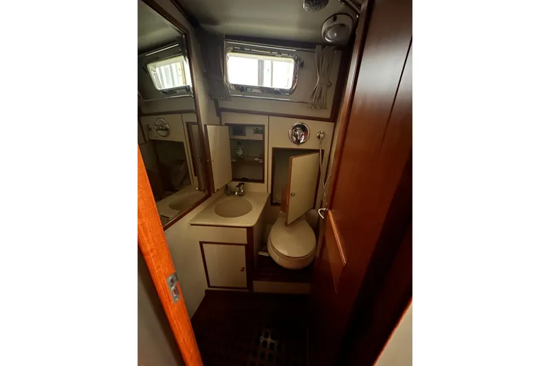 Chief Yacht Photos Pics Bathroom interior of 2000 Grand Banks 43 Eastbay FB yacht, featuring sink and toilet.