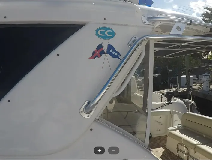 Cc Rider Yacht Photos Pics 2004 Tiara Yachts 4400 Sovran, side view with nautical flags and seating area.