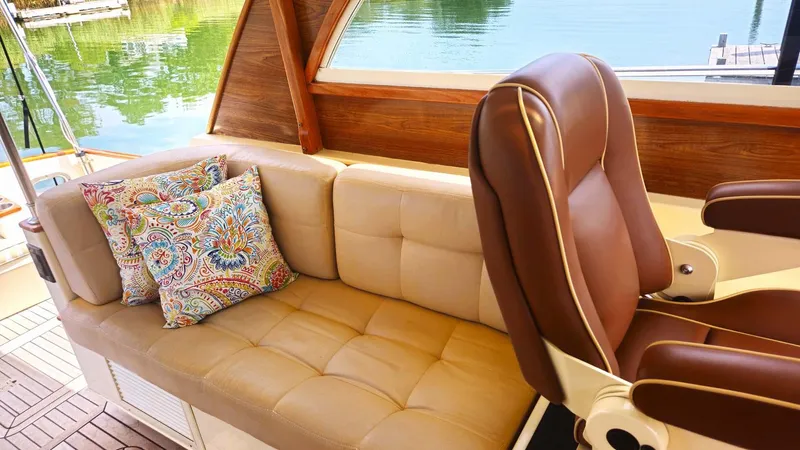 Odyssey III Yacht Photos Pics Luxurious interior of 2008 Legacy 32 boat with leather seating and decorative pillows.
