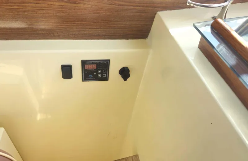 Odyssey III Yacht Photos Pics Control panel on a 2008 Legacy 32 boat with wood accents and switches.