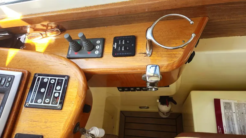 Odyssey III Yacht Photos Pics Control panel of a 2008 Legacy 32 boat with wooden finish and navigation instruments.
