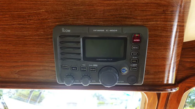 Odyssey III Yacht Photos Pics VHF marine radio on 2008 Legacy 32 boat, mounted on wooden panel.