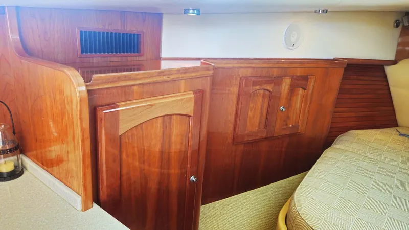Odyssey III Yacht Photos Pics Luxurious wooden interior of a 2008 Legacy 32 boat cabin with elegant cabinetry.