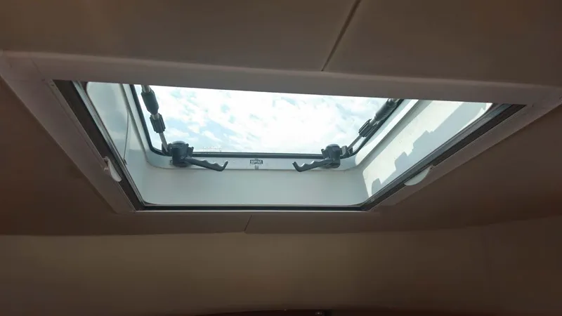 Odyssey III Yacht Photos Pics Skylight view from inside a 2008 Legacy 32 boat, showcasing clear sky.