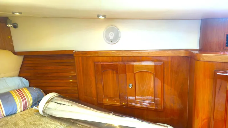 Odyssey III Yacht Photos Pics Interior of 2008 Legacy 32 boat with polished wood cabinetry and speaker.