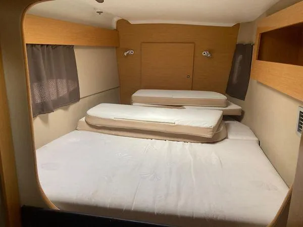  Yacht Photos Pics Interior cabin of 2011 Fountaine Pajot Lipari 41 catamaran with cozy bedding.