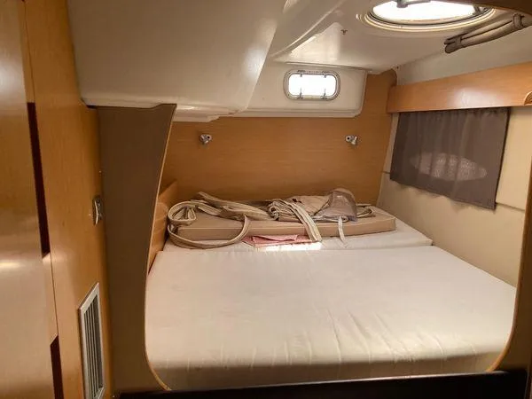  Yacht Photos Pics Cozy cabin interior of 2011 Fountaine Pajot Lipari 41 catamaran with bed and porthole.