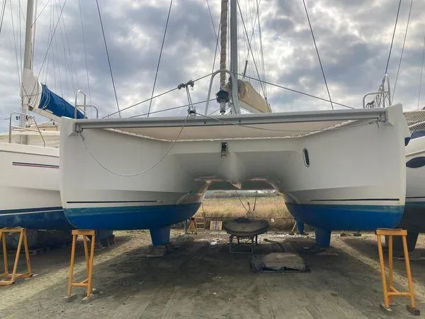 Yacht Photos Pics 2011 Fountaine Pajot Lipari 41 catamaran on land, with blue hull and overcast sky.