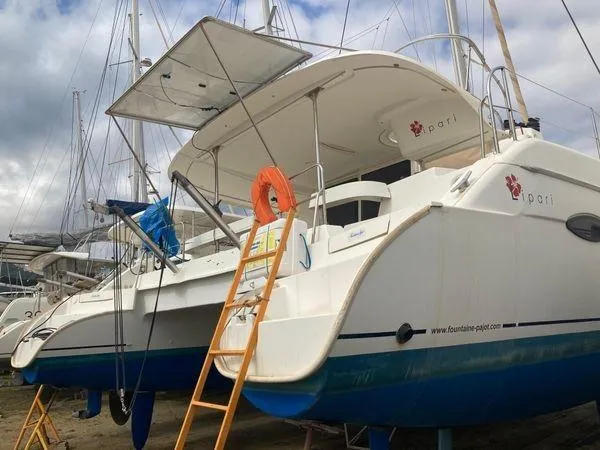  Yacht Photos Pics 2011 Fountaine Pajot Lipari 41 catamaran on land, with ladder and lifebuoy, under cloudy sky.