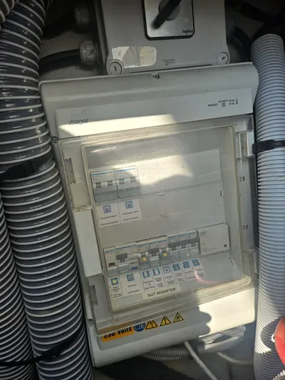  Yacht Photos Pics Electrical panel on a 2011 Fountaine Pajot Lipari 41 catamaran, surrounded by hoses.