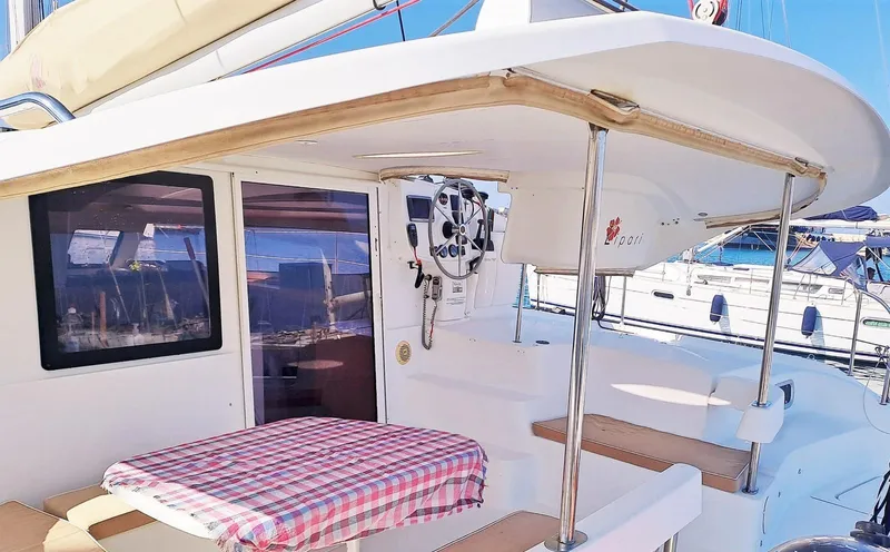  Yacht Photos Pics 2011 Fountaine Pajot Lipari 41 catamaran with outdoor seating and checkered tablecloth.