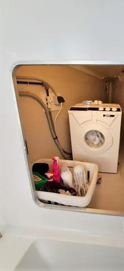  Yacht Photos Pics Laundry area inside 2011 Fountaine Pajot Lipari 41 catamaran with washing machine and supplies.
