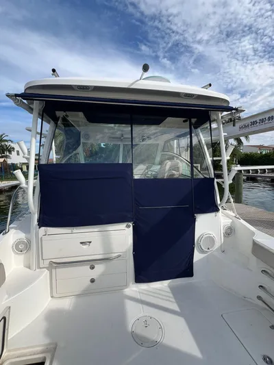  Yacht Photos Pics 2016 Boston Whaler 315 Conquest boat docked, featuring blue canvas covers.