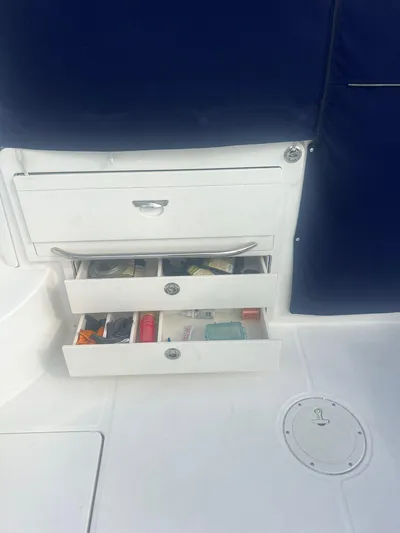  Yacht Photos Pics 2016 Boston Whaler 315 Conquest storage drawers with various items on a boat deck.