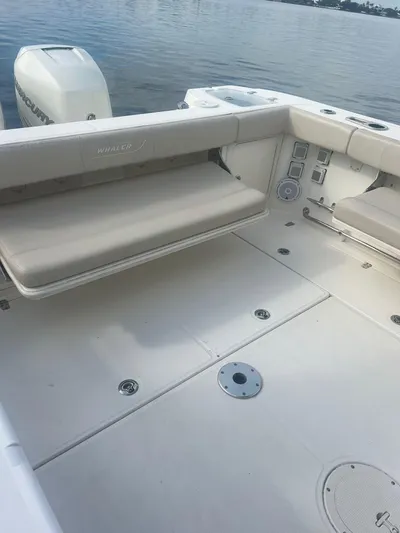  Yacht Photos Pics 2016 Boston Whaler 315 Conquest boat interior with seating, on calm water.