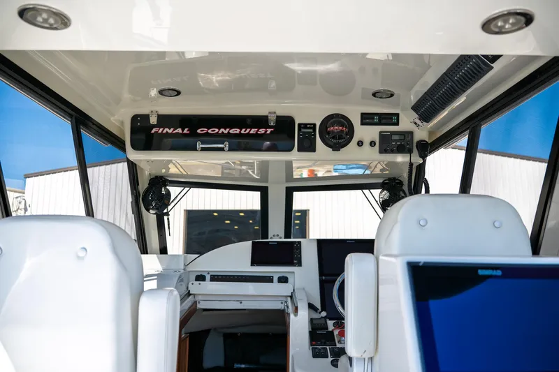  Yacht Photos Pics Interior of 1990 Boston Whaler 31 Offshore Custom Conquest boat cockpit with navigation equipment.