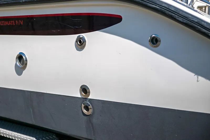  Yacht Photos Pics Close-up of 1990 Boston Whaler 31 Offshore Custom Conquest boat hull with metal fittings.