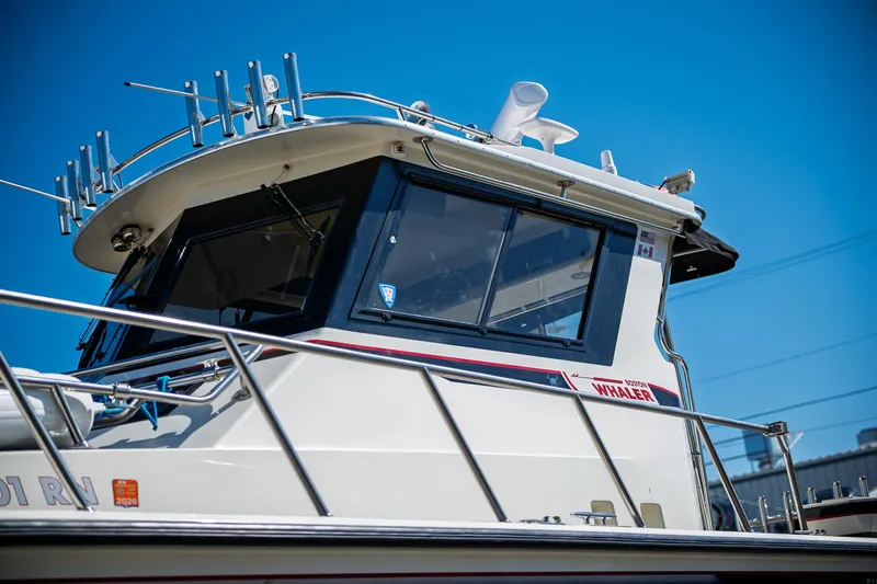  Yacht Photos Pics 1990 Boston Whaler 31 Offshore Custom Conquest boat against clear blue sky.