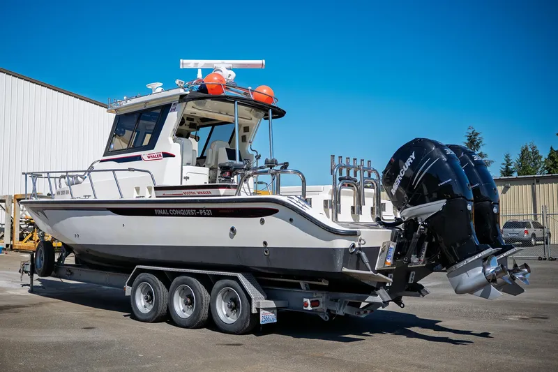  Yacht Photos Pics 1990 Boston Whaler 31 Offshore Custom Conquest on trailer, dual Mercury engines, sunny day.