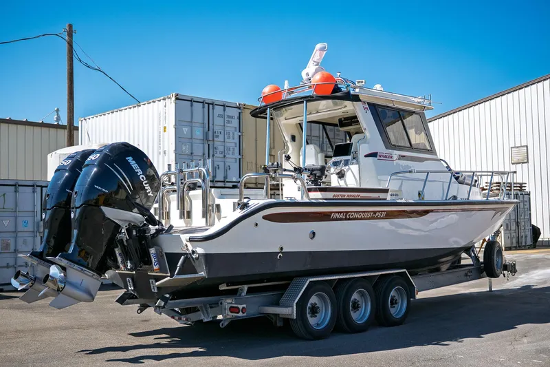  Yacht Photos Pics 1990 Boston Whaler 31 Offshore Custom Conquest boat on trailer, featuring dual Mercury engines.