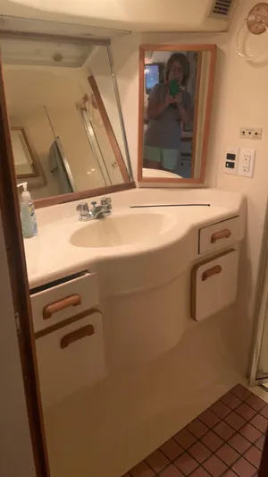 Amusement Yacht Photos Pics Bathroom vanity in 1994 Sea Ray 500 Sundancer yacht, featuring sink and storage cabinets.