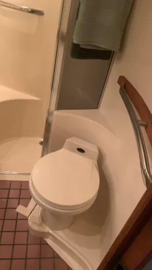 Amusement Yacht Photos Pics Bathroom interior of 1994 Sea Ray 500 Sundancer yacht, featuring toilet and shower area.