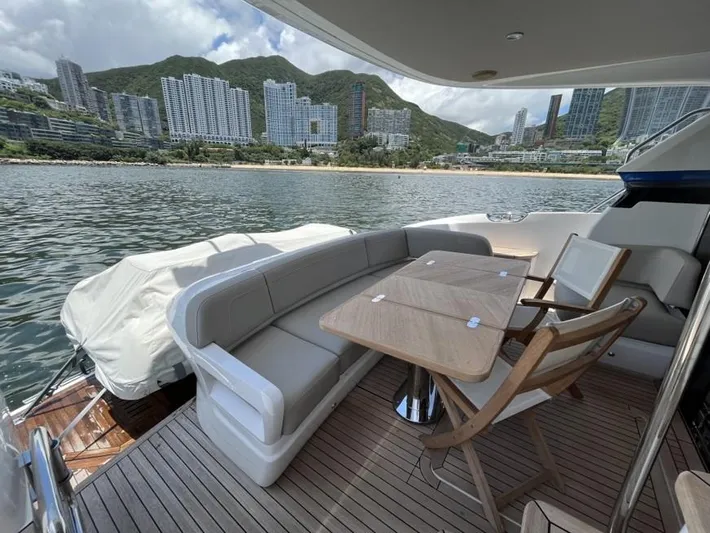  Yacht Photos Pics Luxurious 2020 Princess F45 yacht deck with seating, table, and scenic waterfront city view.