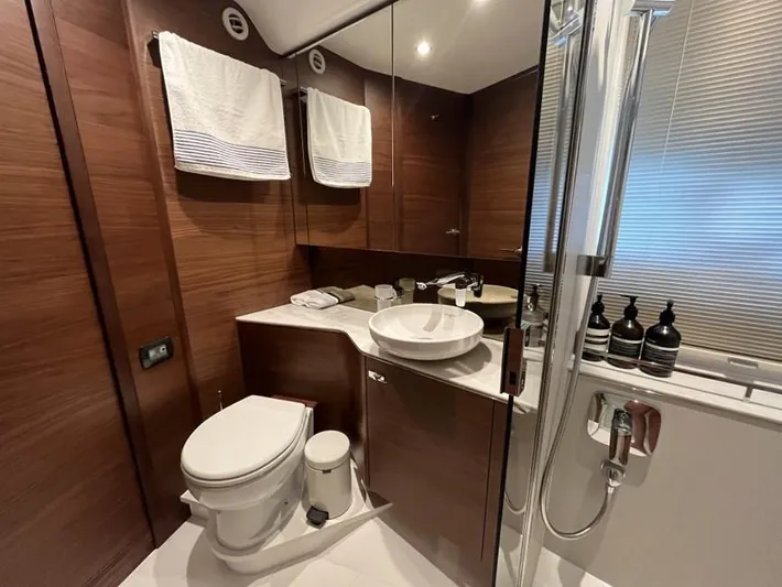  Yacht Photos Pics Luxurious bathroom in 2020 Princess F45 yacht with modern fixtures and wooden accents.
