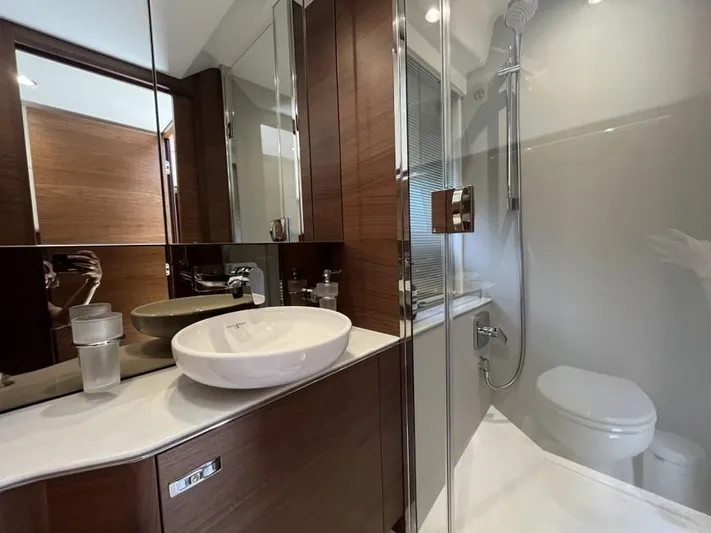  Yacht Photos Pics Luxurious bathroom in 2020 Princess F45 yacht with modern fixtures and elegant wood accents.