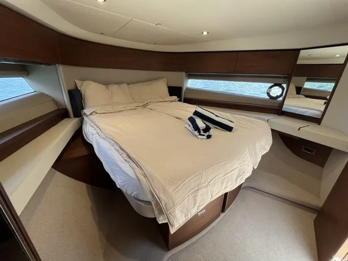  Yacht Photos Pics Luxurious bedroom interior of 2020 Princess F45 yacht with elegant bedding and wood accents.