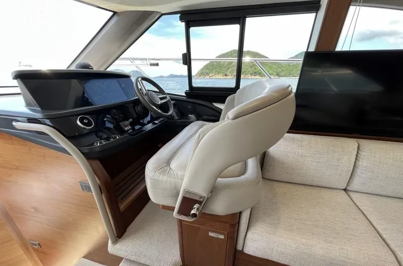  Yacht Photos Pics Luxurious 2020 Princess F45 yacht interior with helm, plush seating, and scenic ocean view.