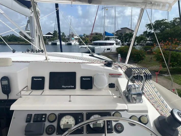 Morning Star Yacht Photos Pics Helm of a 2021 Leopard 40 catamaran with navigation equipment and marina view.