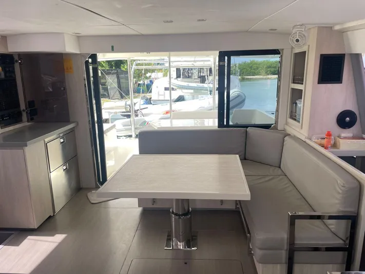 Morning Star Yacht Photos Pics Interior of 2021 Leopard 40 catamaran with modern dining area and waterfront view.