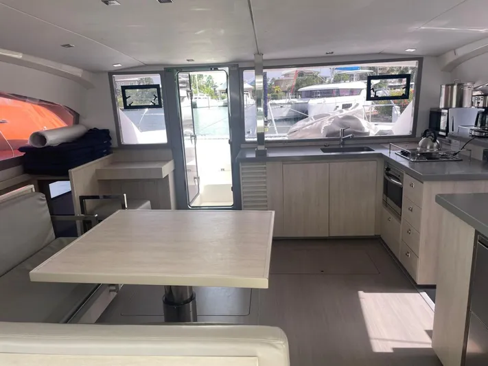 Morning Star Yacht Photos Pics Modern interior of 2021 Leopard 40 catamaran with kitchen and dining area.