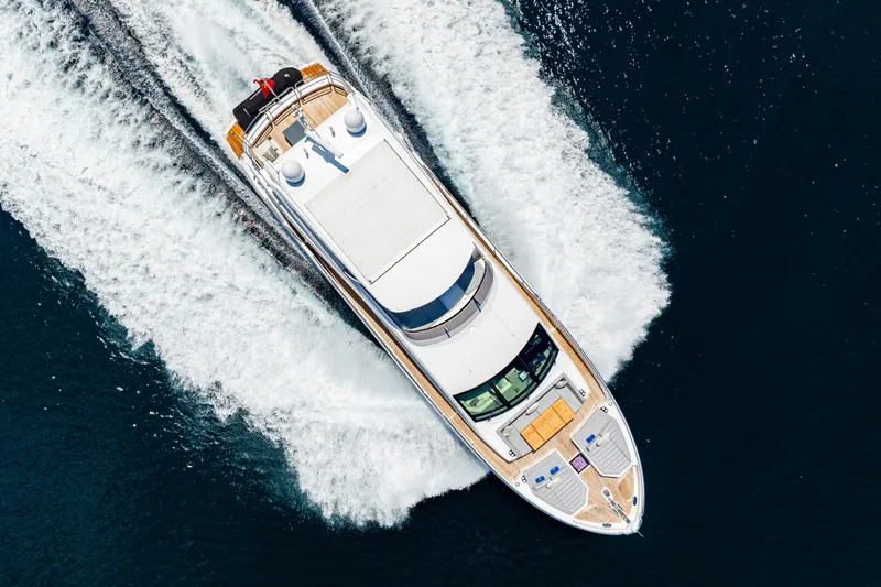  Yacht Photos Pics Aerial view of 2021 Sunseeker 76 Yacht cruising on open water.