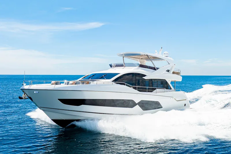  Yacht Photos Pics 2021 Sunseeker 76 Yacht cruising on open sea under clear blue sky.