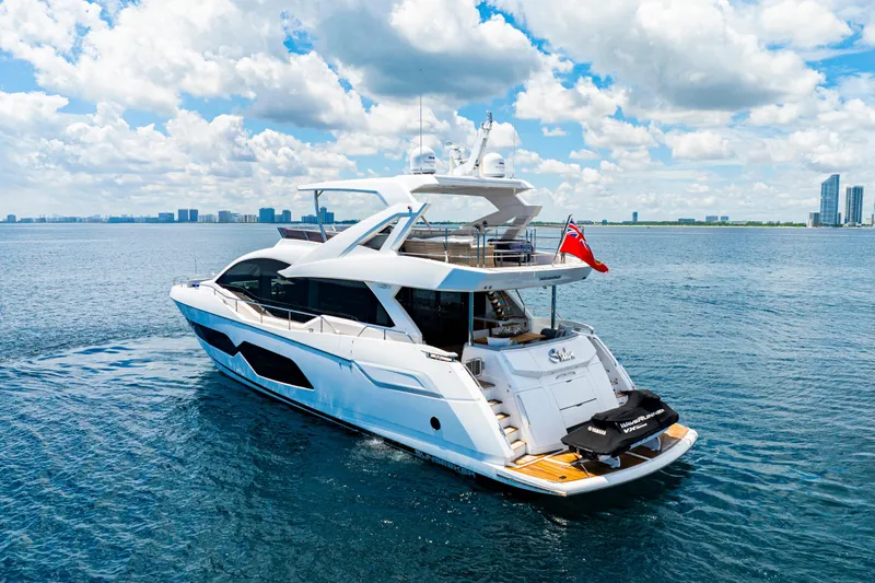  Yacht Photos Pics Luxurious 2021 Sunseeker 76 Yacht cruising on open water under a bright sky.