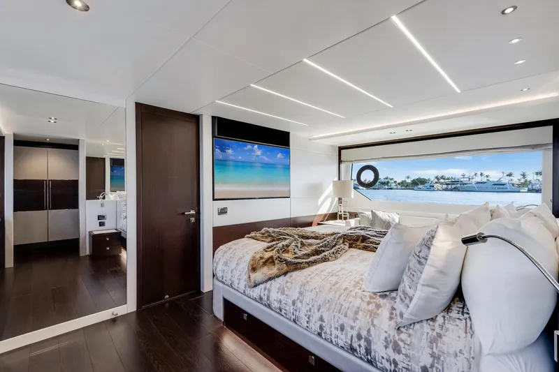  Yacht Photos Pics Luxurious bedroom interior of 2021 Sunseeker 76 Yacht with ocean view and modern decor.
