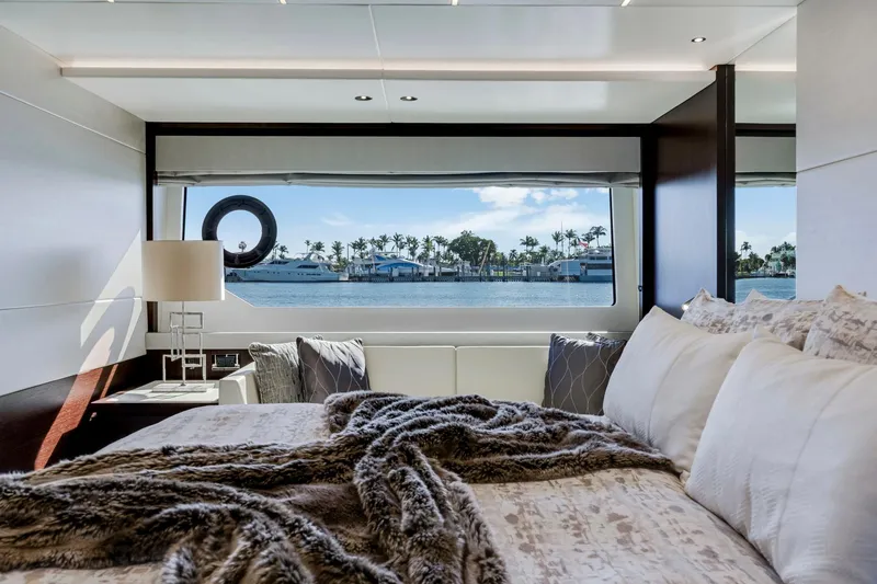  Yacht Photos Pics Luxurious Sunseeker 76 Yacht 2021 bedroom with ocean view through large window.