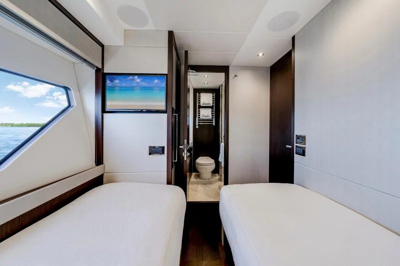  Yacht Photos Pics Luxurious interior of 2021 Sunseeker 76 Yacht cabin with twin beds and ensuite bathroom.