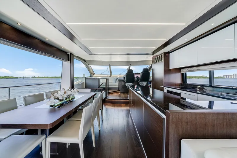  Yacht Photos Pics Luxurious interior of 2021 Sunseeker 76 Yacht with modern dining and helm area.
