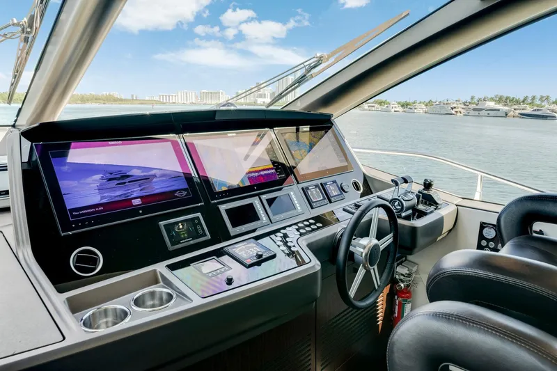  Yacht Photos Pics Helm of 2021 Sunseeker 76 Yacht with advanced navigation displays and steering wheel.