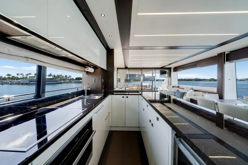  Yacht Photos Pics Luxurious interior of 2021 Sunseeker 76 Yacht with modern kitchen and scenic water views.