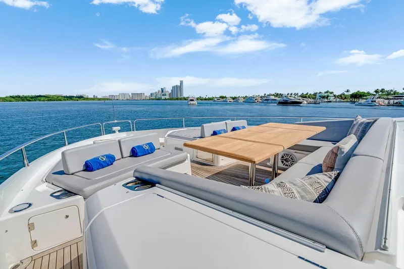  Yacht Photos Pics Luxurious Sunseeker 76 Yacht 2021 with elegant outdoor seating and scenic ocean view.