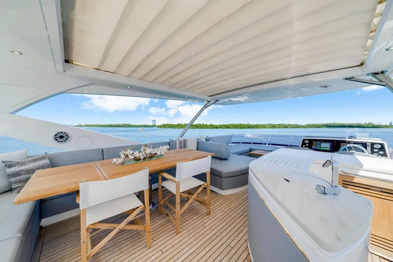  Yacht Photos Pics Luxurious Sunseeker 76 Yacht 2021 with elegant outdoor seating and scenic ocean view.