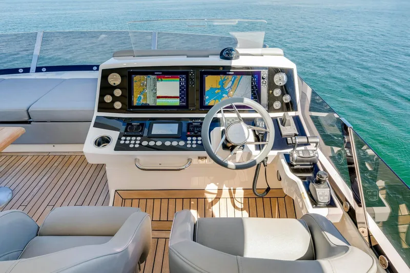  Yacht Photos Pics Helm of 2021 Sunseeker 76 Yacht with modern navigation systems and luxurious seating.
